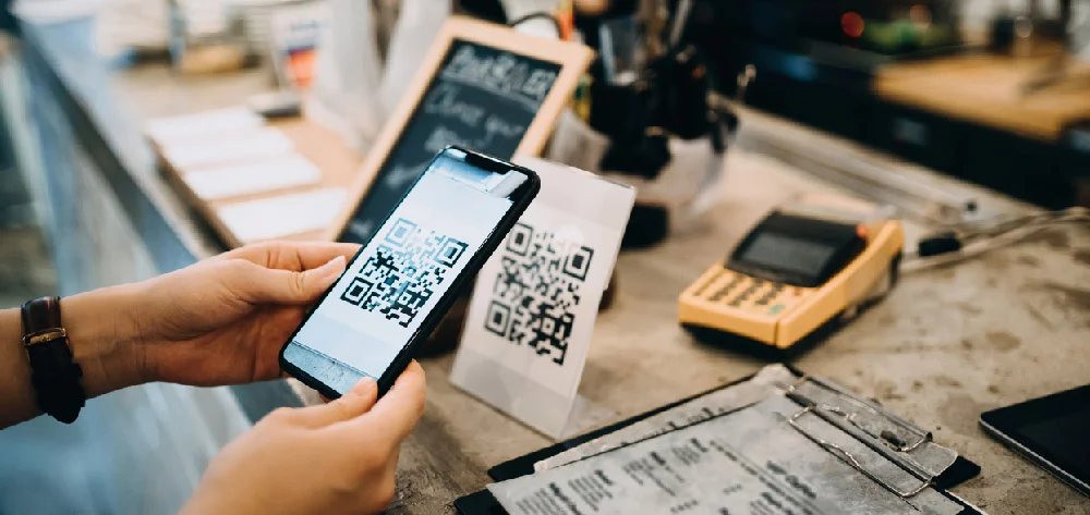 Customer Scanning Qr Code Making a Quick and Easy Contactless Payment with Her Smartphone in a Cafe